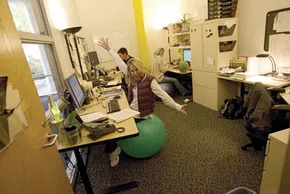 Employee On Exercise Ball at Desk